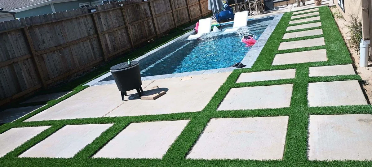 Pool with artificial turf pavers and modern landscaping