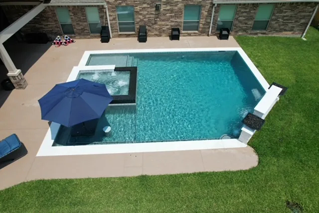 Pool with raised spa and water features aerial view