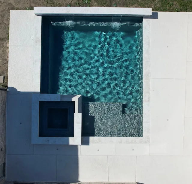 Modern square pool with geometric spa aerial view