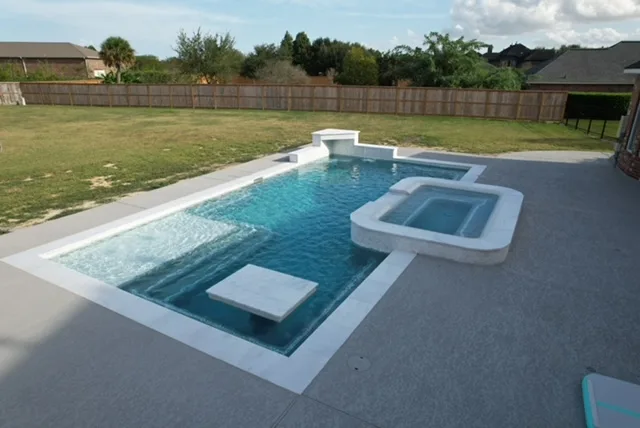 Geometric pool with tanning ledge and attached spa