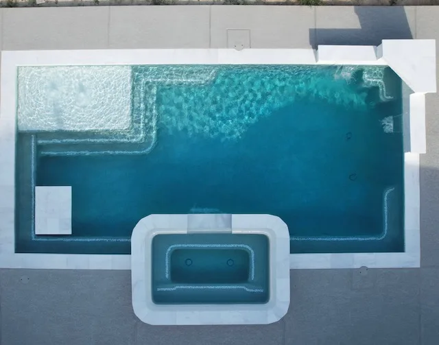 Geometric pool with attached spa aerial view by Pools of Houston