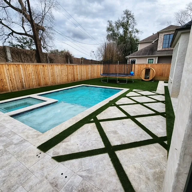 Backyard pool with spa, turf pavers, and playground