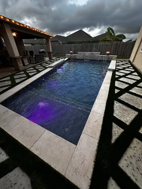 Pool with LED lighting and pergola at dusk
