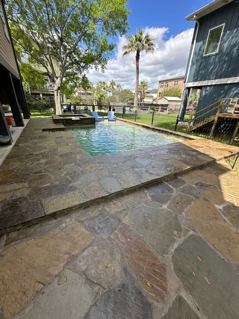 Flagstone beach entry pool with natural stone deck