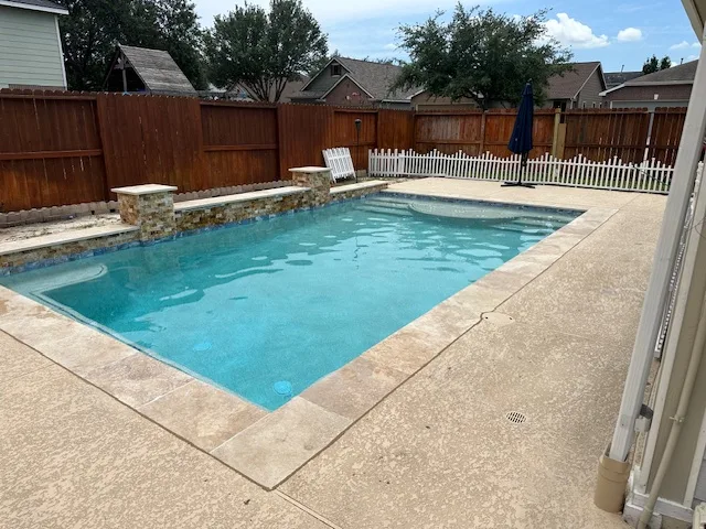 Pool with stone wall and mounted water features