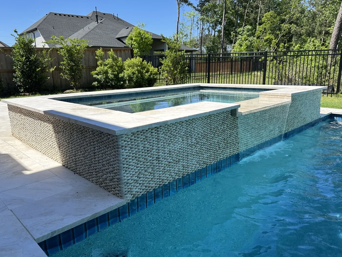 Outdoor living pool area by Pools of Houston in Woodstone Reserve, Spring TX
